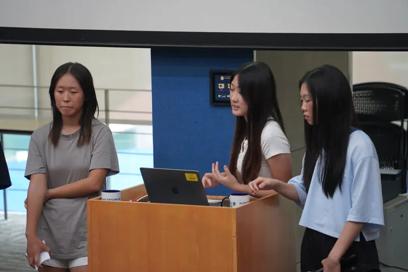 Students demo their product at the podium