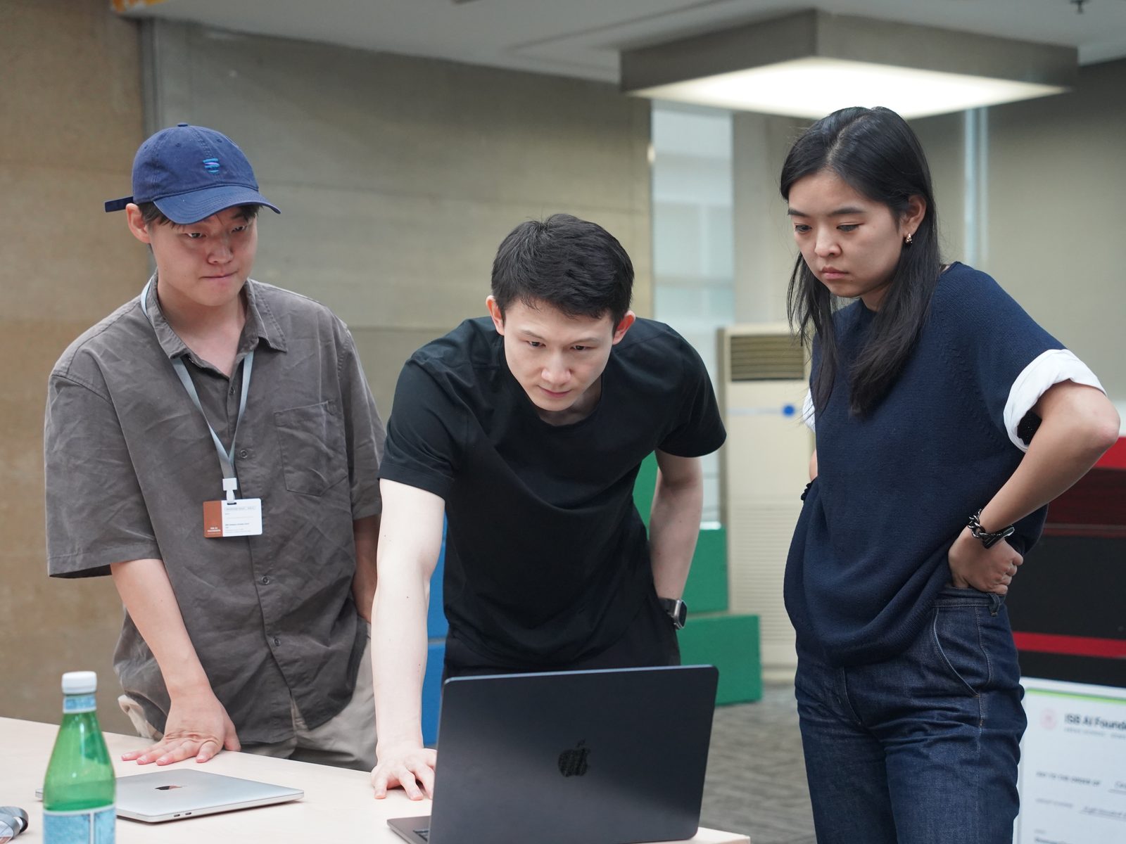 Judges trying a student product on a laptop